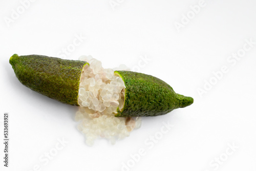 Finger lime or caviar lime of Australian cut in half, it is edible fruits used for cooking gourmet cuisine. Fresh Citrus australasica isolated on white background.