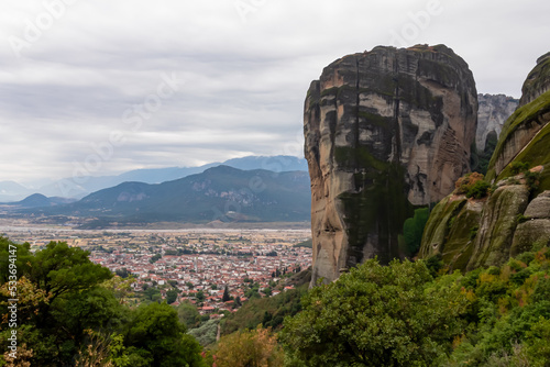 Panoramic aerial view of summit rock Aghio Pnevma (Holy Spirit) and tourist village of Kalambaka, Thessaly, Greece, Europe. Kastraki and the Pindus mountains. Dramatic rock complex of Meteora