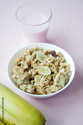 Home Made Musli in a bowl on light pink background 