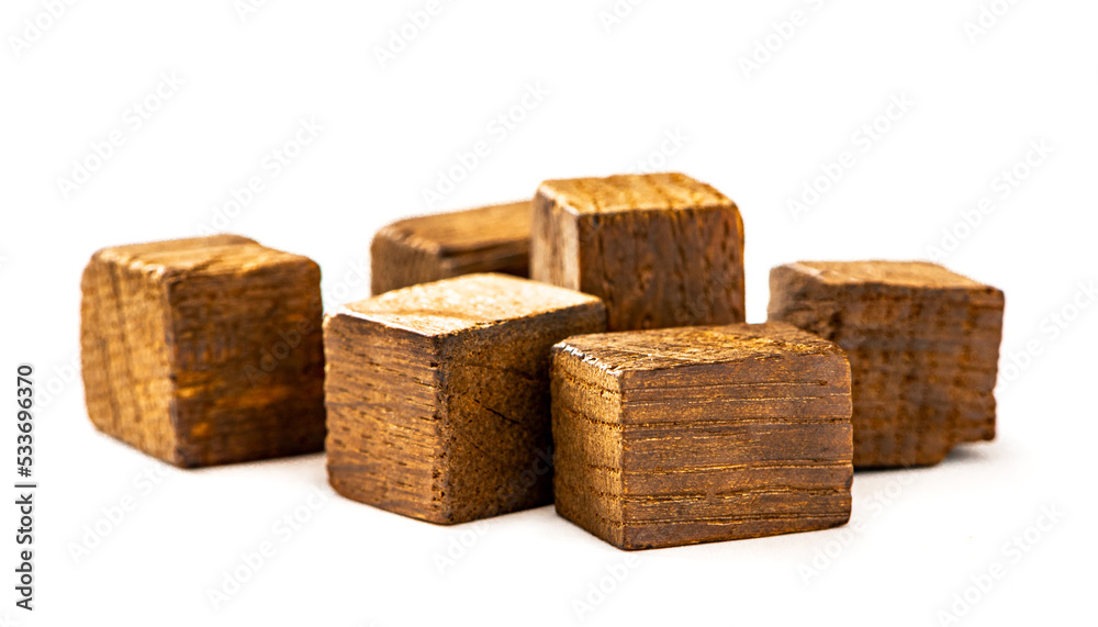 Smoked oak chips for home brewing. Wooden smoked blocks isolated on white background. Wood chips for home brew beer and wine making. Smoked oak chips for home brewing. Wooden smoked blocks isolated on white background. Wood chips for home brew beer and wine making.