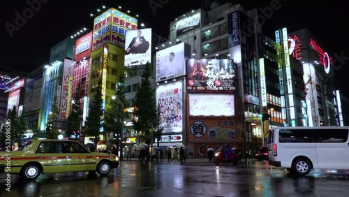 Neon lights and billboard advertisements on buildings at Akihabara at rainy night, Tokyo, Japan