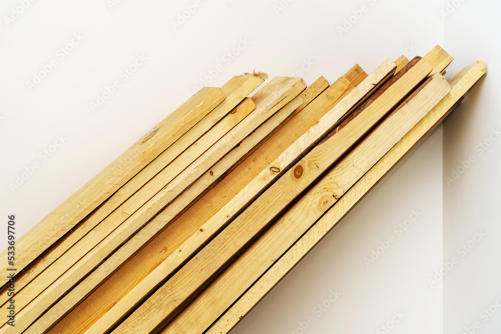 Wooden boards. A stack of lumber for the construction of various structures. Close-up. White background