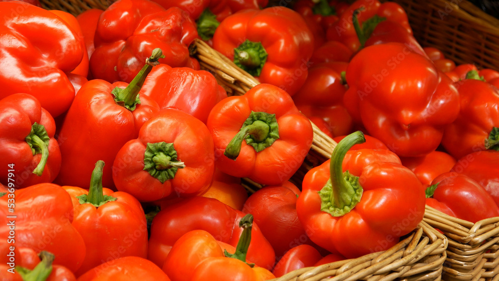 Close-up of many red bell peppers in wicker baskets Close-up of many red bell peppers in wicker baskets
