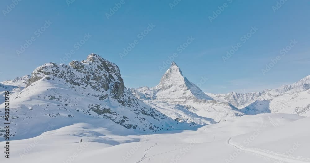 Aerial drone flyover Gornergrat with Matterhorn view during winter in Switzerland. Majestic mountain peaks iconic famous zermatt travel ski resort in the alps. Wonderful inspiring nature landscape. Aerial drone flyover Gornergrat with Matterhorn view during winter in Switzerland. Majestic mountain peaks iconic famous zermatt travel ski resort in the alps. Wonderful inspiring nature landscape.