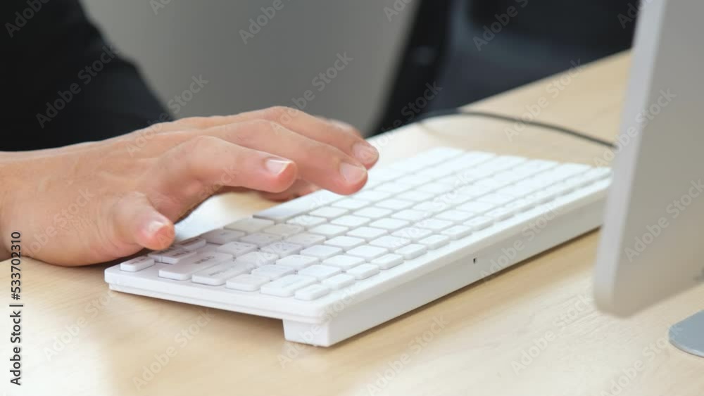 man's hand typing fingers on white keyboard man's hand typing fingers on white keyboard