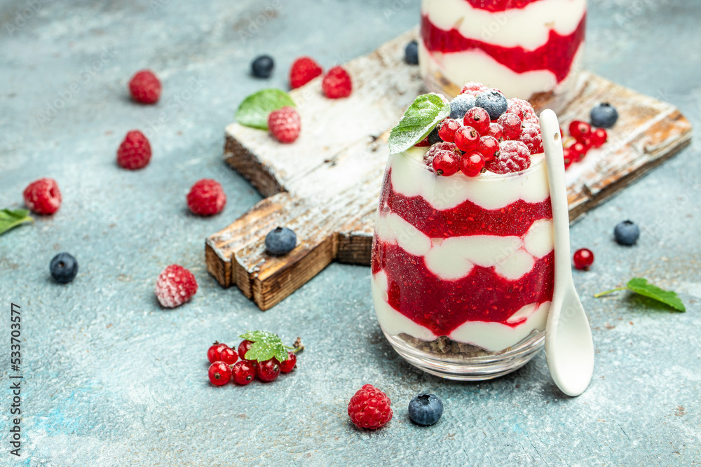 Scottish dessert whipped cream, roasted oatmeal and raspberries in jar. banner, menu, recipe place for text, top view Scottish dessert whipped cream, roasted oatmeal and raspberries in jar. banner, menu, recipe place for text, top view