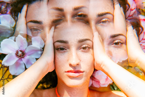 Multiple exposure of young woman with head in hands photo