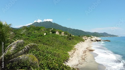 Santa Marta Colombia , Tayrona Natural Park Caribbean sea ocean - Drone aerial view of amazing  sand beach and  forest full of palm trees vegetation - deserted and paradise beach for summer vacation photo