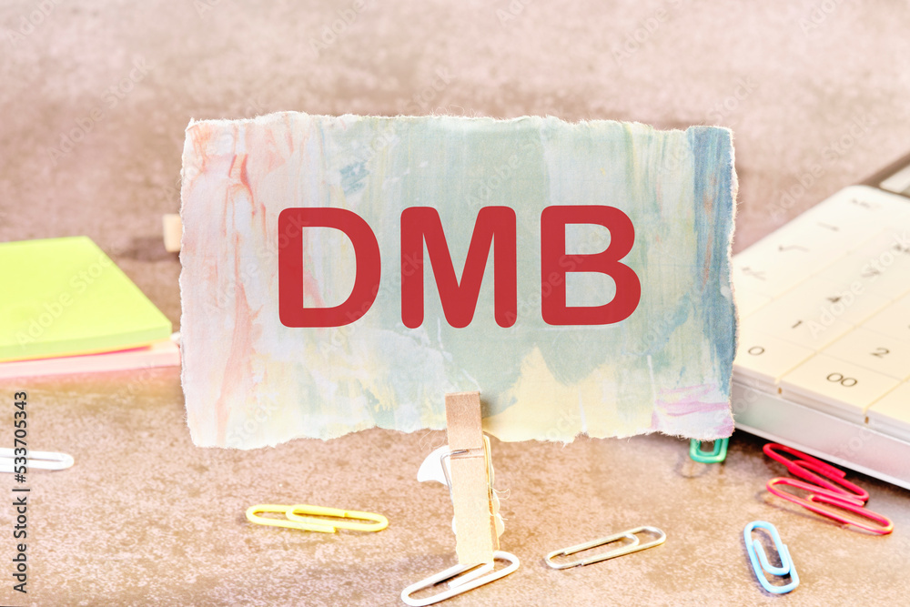 dmb text on a piece of colored paper held by a clothespin next to ...