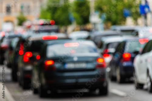 Defocused traffic jam at rush hour. Cars being in line and waiting to move © madrolly
