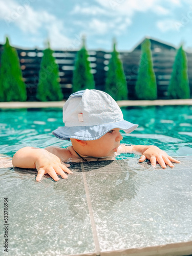 Cute baby boy spending time in the swimming pool