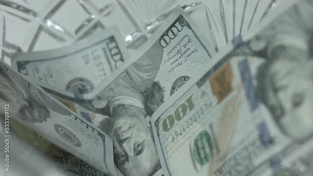 100 Dollar Bills Fall, Drop Into Crystal Bowl Close Up