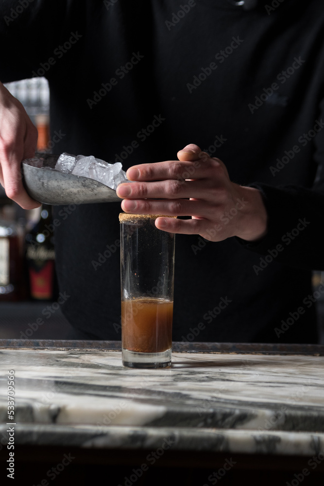 Pouring ice into cocktail