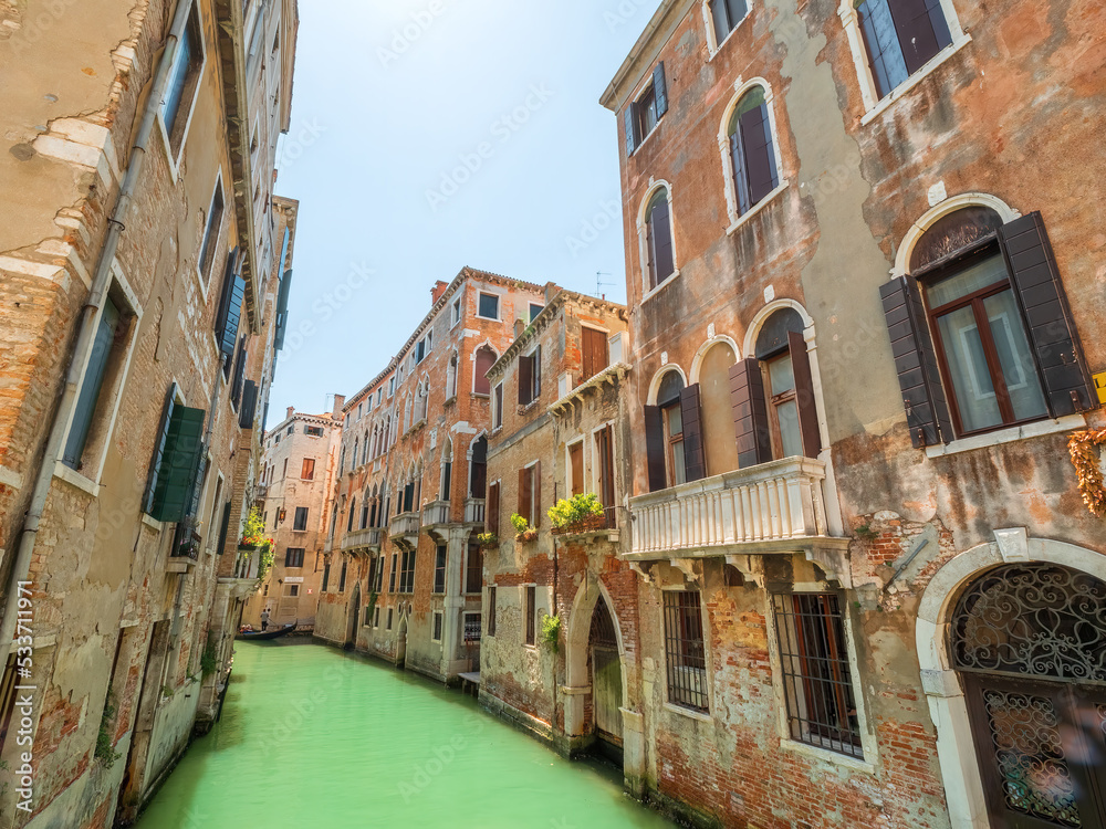 Venezia Wall Architecture along the crystal clear water canal during summer time