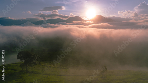 A typical view of sunrise with ground still covered in fog or mist in pangalengan, west java. It was taken in September 24th, 2022 from a place called Nimo highland in Pangalengan photo
