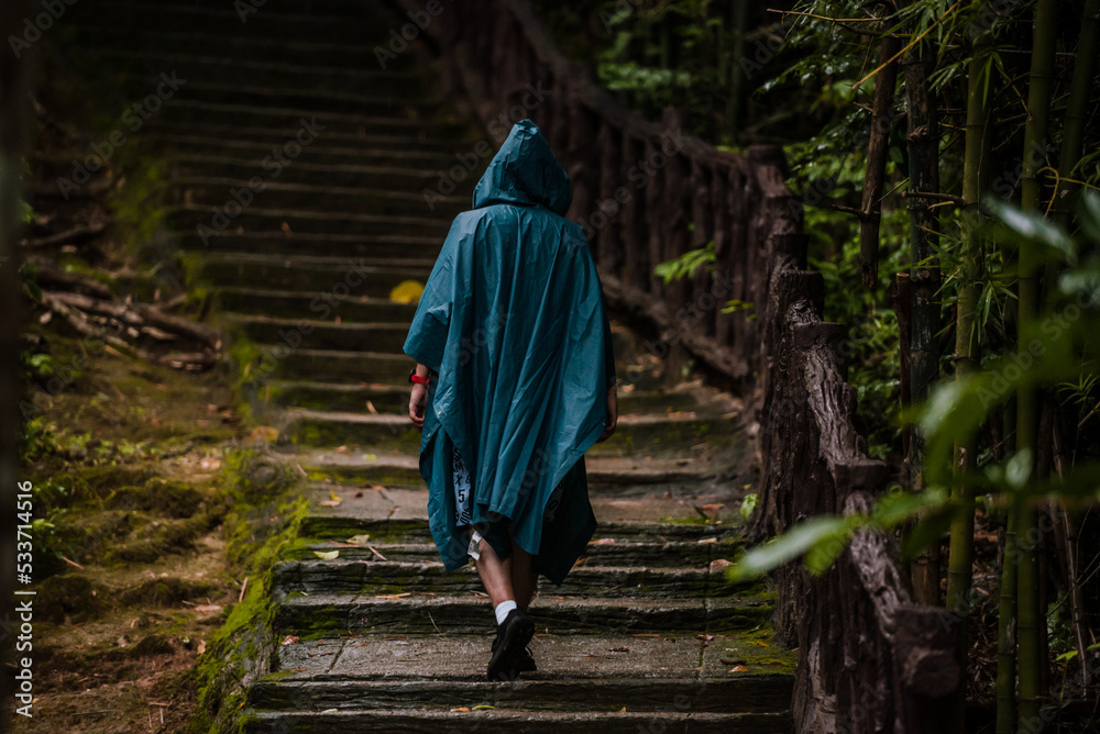 Man wearing a raincoat walking in the nature Man wearing a raincoat walking in the nature