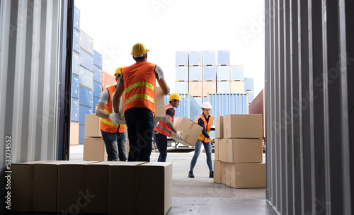Men worker loading cardboard boxes into containers, Warehousing and logistic shipping cargo concept photo