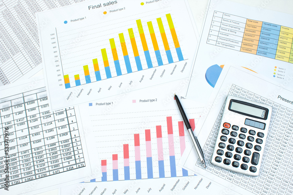 Financial printed paper charts, graphs and diagrams on the table. Top view