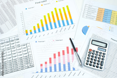 Financial printed paper charts, graphs and diagrams on the table. Top view