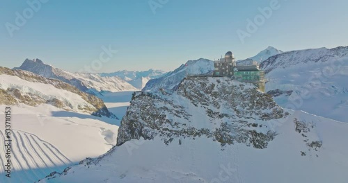 Aerial drone fly over Sphinx observatory and Aletsch glacier on Jungfraujoch, Swiss Alps, Switzerland. Jungfrau top of europe in interlaken one of the highest mountain in the world on winter sunny day photo