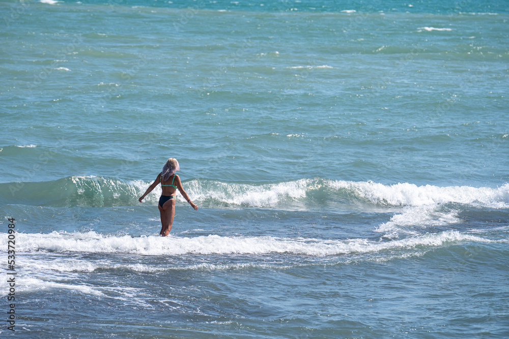 Fototapeta premium Blonde in a bikini in the se