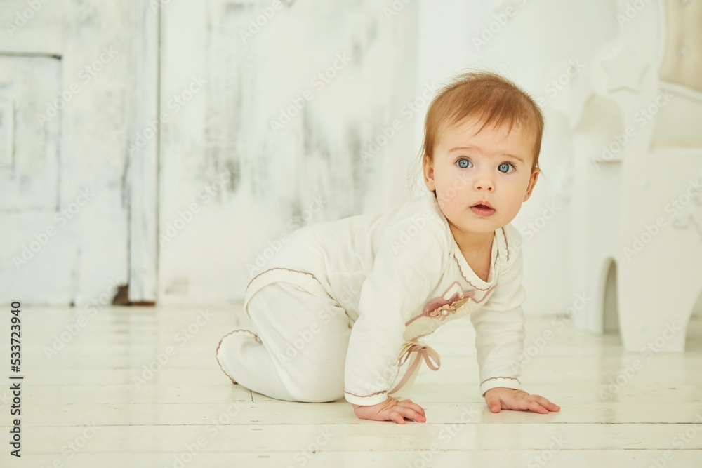 Fototapeta premium A small newborn baby is in a bright room. The concept of childhood
