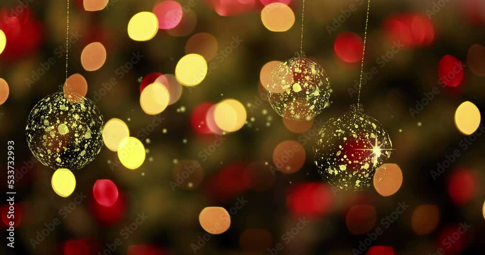 Animation of gold christmas baubles swinging over defocussed red and yellow flashing fairy lights Animation of gold christmas baubles swinging over defocussed red and yellow flashing fairy lights