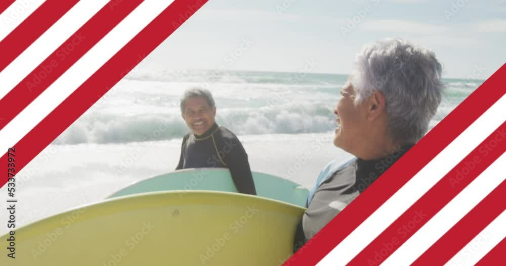 Animation of flag of united states of america over senior biracial couple with surfboard on beach Animation of flag of united states of america over senior biracial couple with surfboard on beach