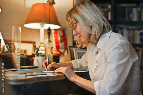 portrait of an elderly lady while she writes