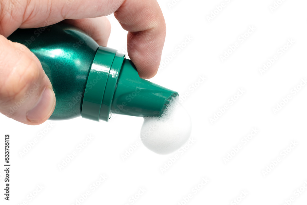 The hand holds a balloon with soap foam. Shaving foam. Skin care The hand holds a balloon with soap foam. Shaving foam. Skin care