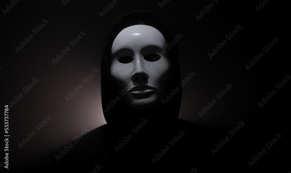 Man wearing mask with hoodie on black background. Man wearing mask with hoodie on black background.
