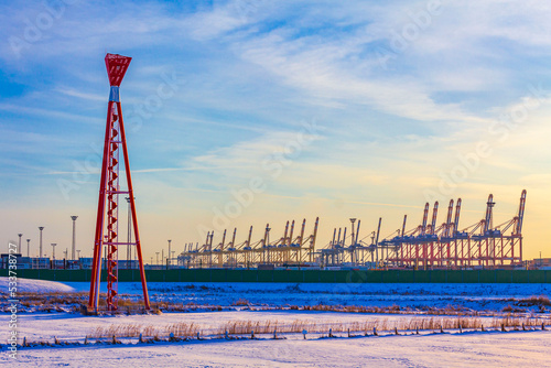 Shipyard cranes shipyard crane sunset winter container port Bremerhaven Germany. photo