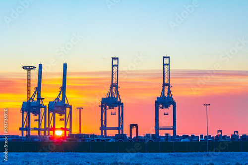 Shipyard cranes shipyard crane sunset winter container port Bremerhaven Germany. photo