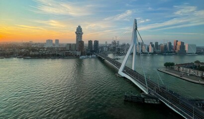 Fototapete Erasmusbrücke Erasmusbrücke Rotterdam bei bewölktem Sonnenuntergang  © Dipak Changur/Wirestock Creators