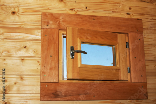 Wooden window on a wooden wall closeup