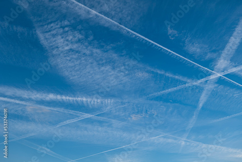Pattern of several aircraft contrails in the blue sky photo