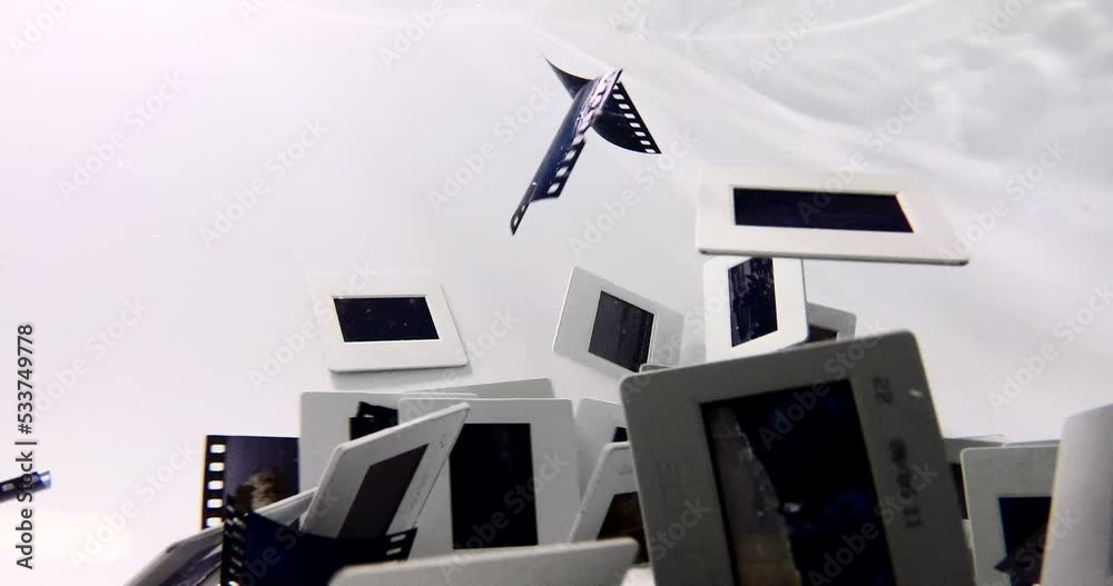 35mm film slides swimming under the water shuffling hovering spreading and moving light shines through old photos with beautiful colors waves experimental film full hd high quality