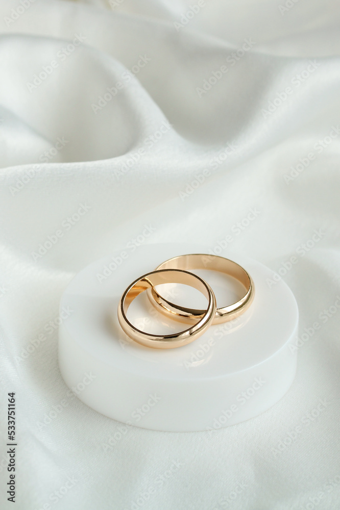 Wedding background with two gold rings on white satin material. Marriage. Wedding background with two gold rings on white satin material. Marriage.
