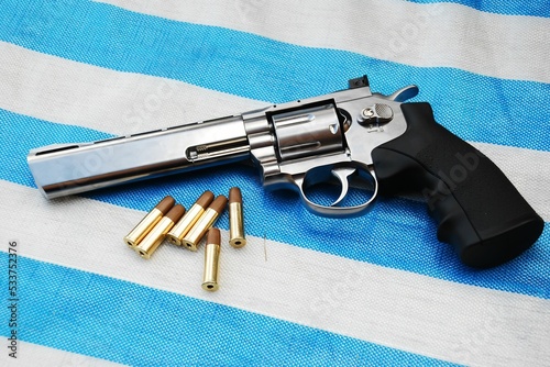 Closeup of an airgun on white and blue background photo