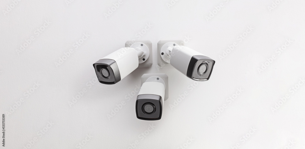 Three security cameras mounted on wall