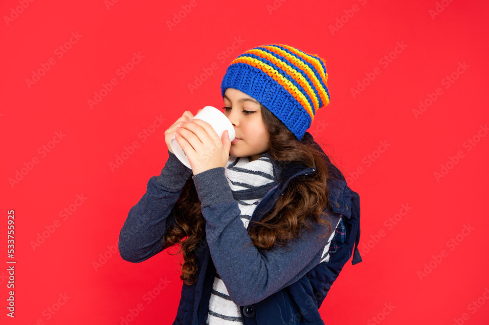 portrait of child with coffee cup. drinking cocoa and milk. kid in puffer waistcoat and hat. portrait of child with coffee cup. drinking cocoa and milk. kid in puffer waistcoat and hat.