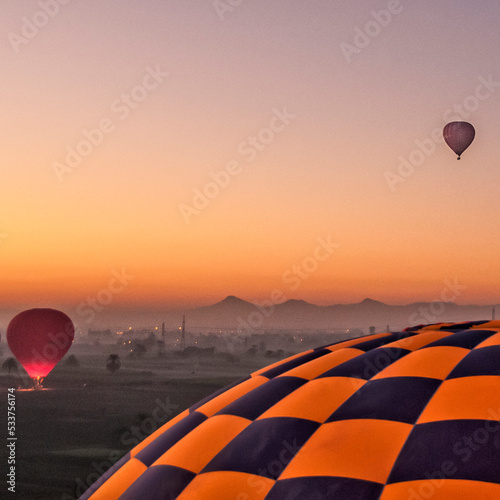Valokuva Hot air balloons rising at daybreak over Luxor, Egypt