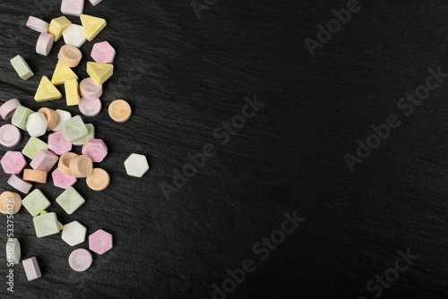 Fotografie Scattered Tablet Candies on Black, Compressed Tablets