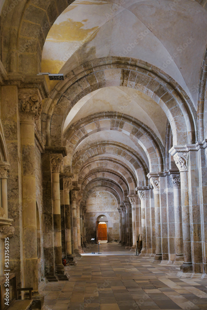 Side aisle with arches of the medieval basilica Sainte-Marie-Madeleine in Vézelay, Burgundy, Morvan, France, a Unesco wold heritage site.