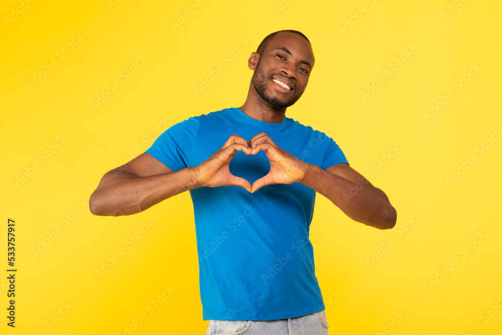Cheerful African American Guy Gesturing Finger Heart Over Yellow Background Cheerful African American Guy Gesturing Finger Heart Over Yellow Background