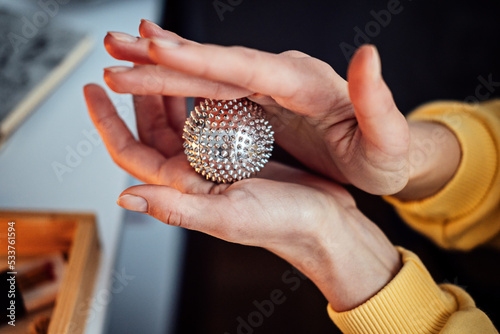 Hand massage Acupuncture Su Jok ball for hands and fingers. Sujok, su jok, su-jok traditional Chinese medicine therapy massage. Sujok Pain Therapy Finger Massager Circulation balls on female hands photo