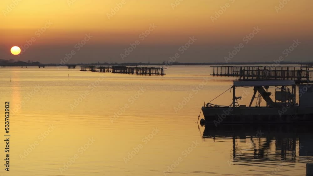 Sunset in Sacca di scardovari, Delta del Po, Comacchio lagoon, sunny day in Veneto, Emilia Romagna, Italy. Calm and peaceful concept and atmosphere. Sunset Rovigo sea Sunset in Sacca di scardovari, Delta del Po, Comacchio lagoon, sunny day in Veneto, Emilia Romagna, Italy. Calm and peaceful concept and atmosphere. Sunset Rovigo sea