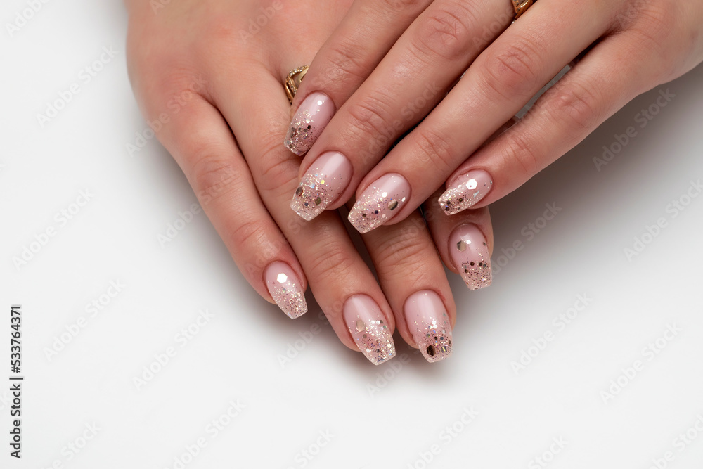 Festive manicure on long nails. Bolero nail shape. Confetti on nails, balls, sparkles