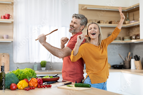 Obraz na plátně Emoitonal husband and wife having fun while cooking