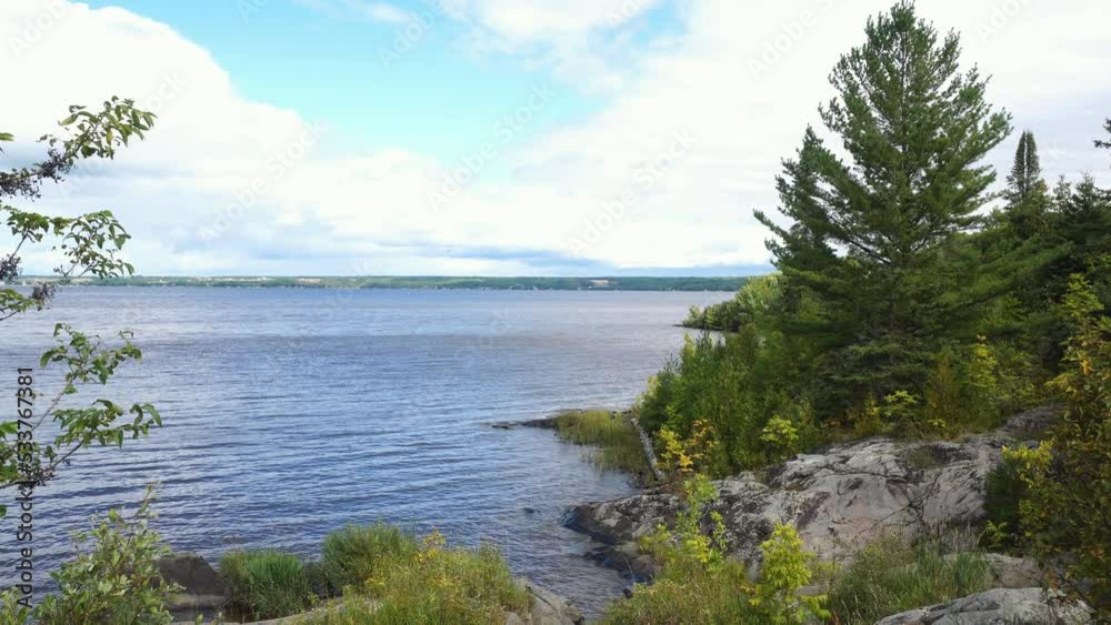 Scenic view of Lake Temirskaming with rocky shoreline in the city of Termiskaming Shores, the province of Quebec is on the horizon. Scenic view of Lake Temirskaming with rocky shoreline in the city of Termiskaming Shores, the province of Quebec is on the horizon.